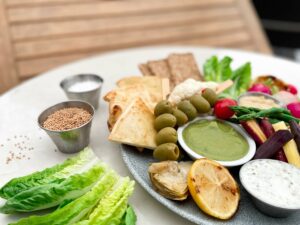 tapas plate with hummus olives tzatziki and crisp breads